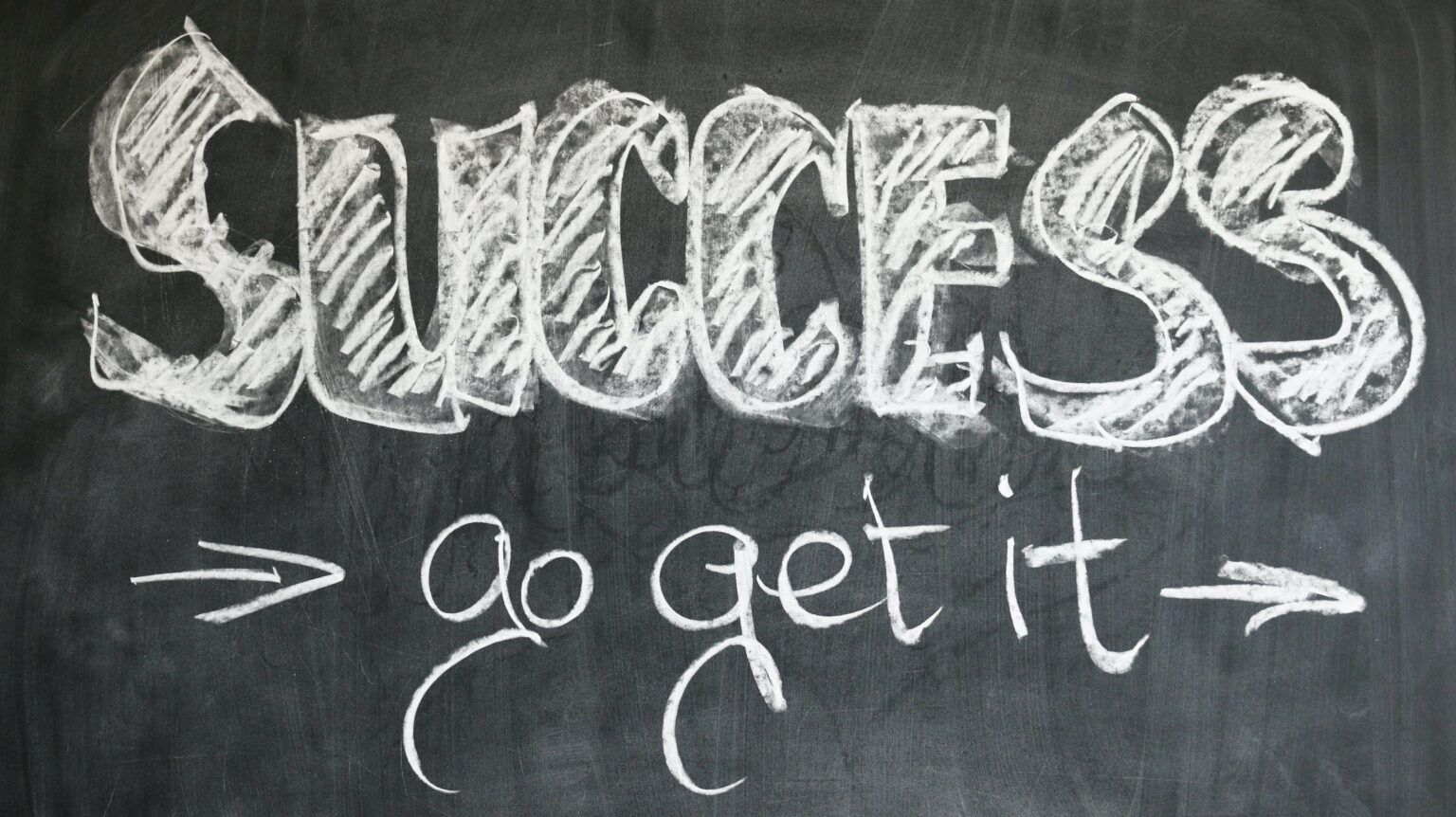 the phrase sucess on a blackboard with chalk