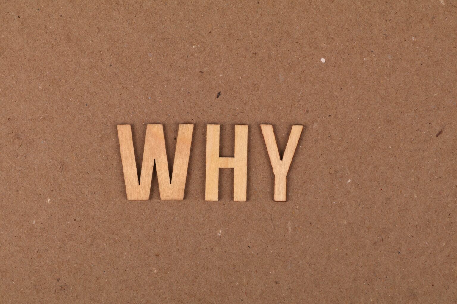 the word why on some brown sand