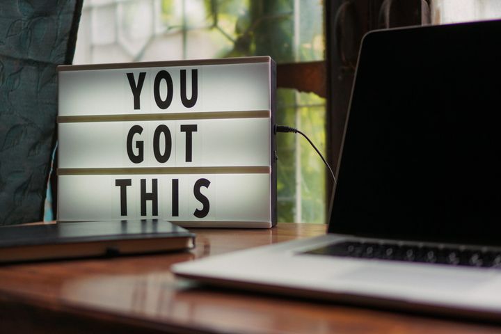 you got this desk sign next to a laptop