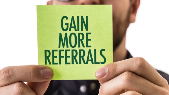 man holding gain more referrals post it note